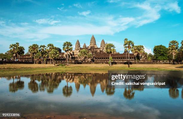 angkor wat temple against sky during sunset, reflected in the water, siem reap, cambodia - angkor wat stock pictures, royalty-free photos & images