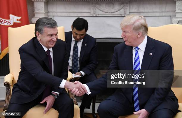President Donald Trump, right, shakes hands with Shavkat Mirziyoev, Uzbekistan's president, during a meeting in the Oval Office of the White House in...