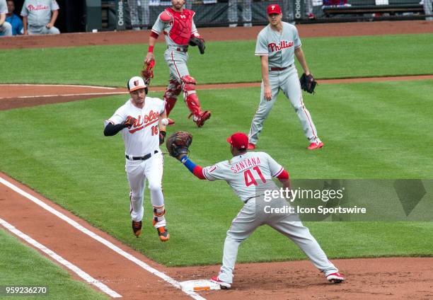 Philadelphia Phillies first baseman Carlos Santana takes a toss from starting pitcher Nick Pivetta to get Baltimore Orioles left fielder Trey Mancini...