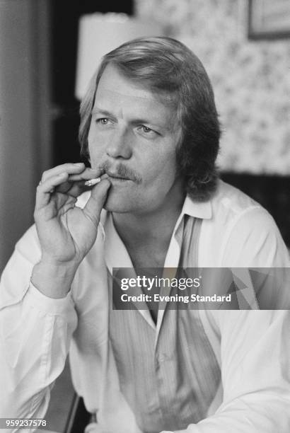 American actor David Soul smoking a cigarette, UK, 18th May 1978.