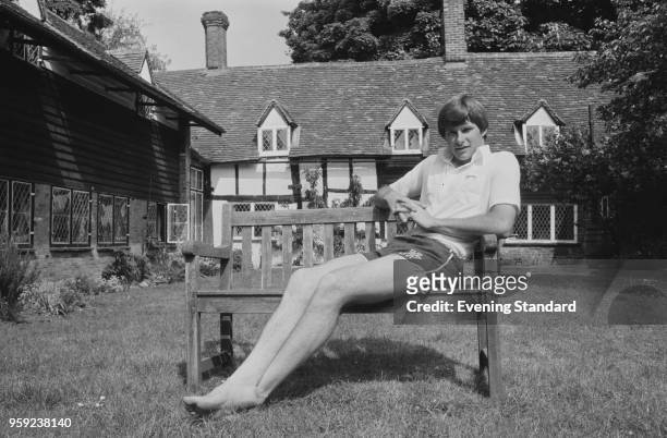 English professional golfer Nick Faldo relaxing on bench in a back yard, UK, 30th may 1978.