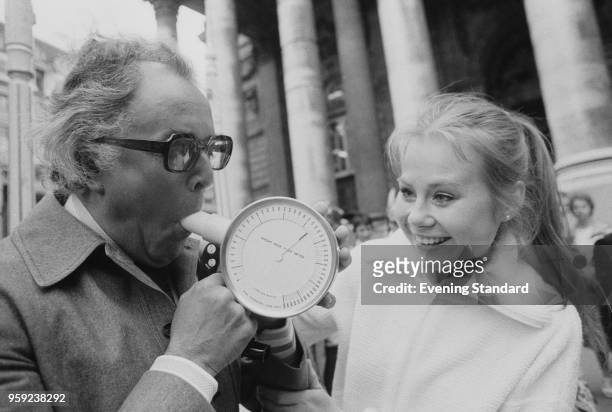 British actress and performer Shirley Cheriton helping British actor and activist Brian Rix to breath into a peak flow meters, London, UK, 23rd June...