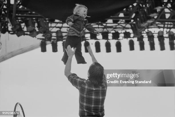 British musician and singer-songwriter Phil Collins playing with his son Simon on the stage of A Midsummer Night's Dream festival, Knebworth...