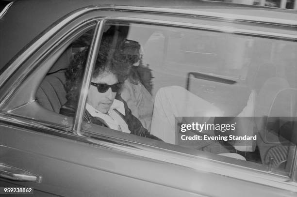 American singer-songwriter, author, and painter Bob Dylan sitting inside a car while travelling to Earls Court, UK, London, 15th June 1978.