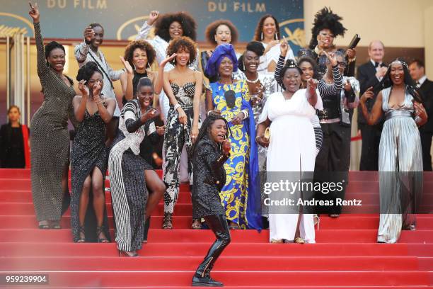 Authors of the book "Noire N'est Pas Mon Métier" dance on the stairs with Jury member Khadja Nin at the screening of "Burning" during the 71st annual...