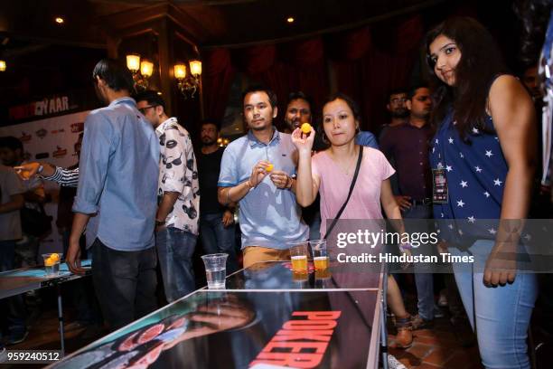 People enjoy during an event "Beer Pong Slam" hosted by Time Machine - The Time Traveller's Pub, on May 12, 2018 in Noida, India.