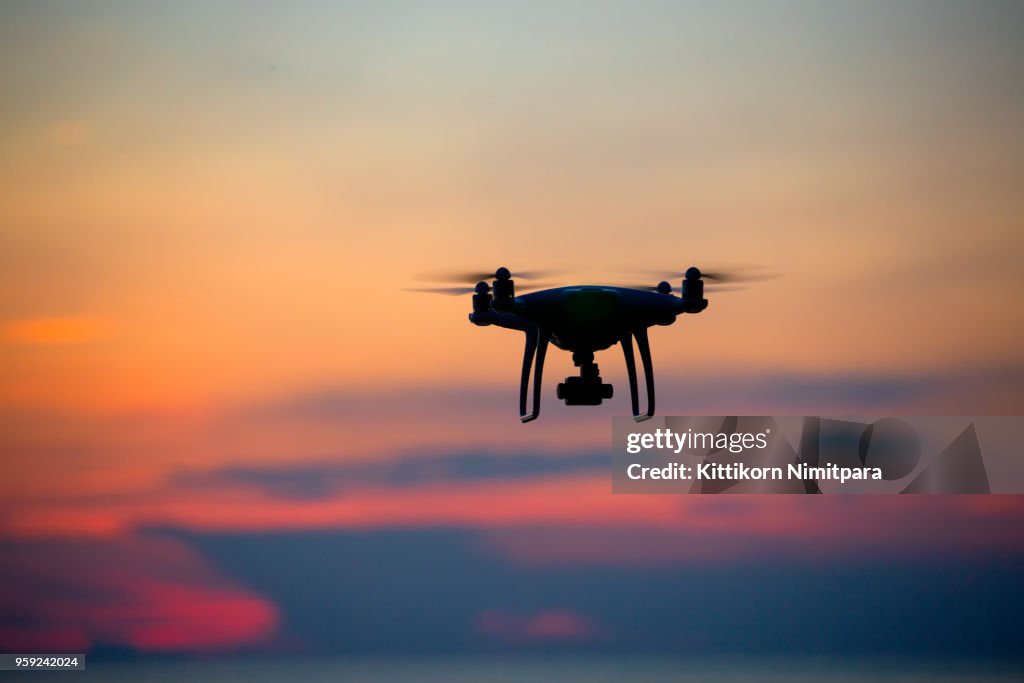 The drone in sunset sky.