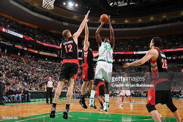 Kendrick Perkins of the Boston Celtics shoots against Andrea Bargnani and Rasho Nesterovic of the Toronto Raptors during the game on January 2, 2010...