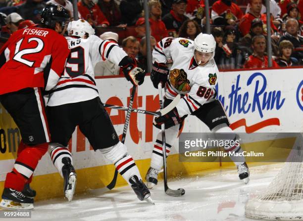 Patrick Kane of the Chicago Blackhawks, handles the puck as Jonathan Toews blocks Mike Fisher of the Ottawa Senators in a game at Scotiabank Place on...