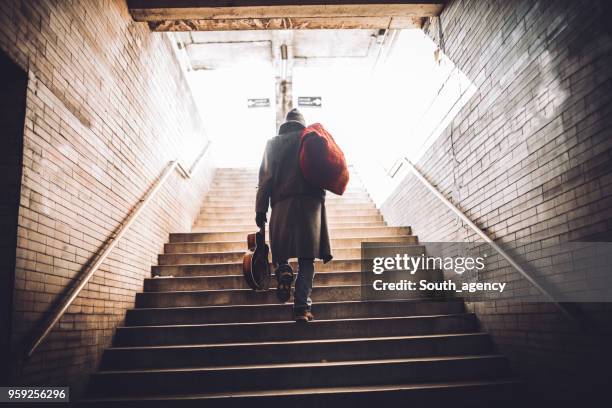 street performer walking up the steps - homeless man stock pictures, royalty-free photos & images