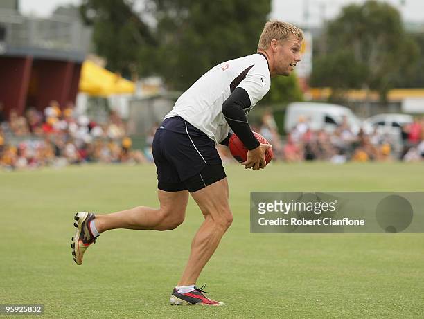 Sam Mitchell of the Hawks runs with the ball during a Hawthorn Hawks AFL training session at Toomuc Recreation Reserve on January 22, 2010 in...