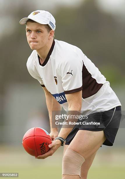 Taylor Duryea of the Hawks handballs during a Hawthorn Hawks AFL training session at Toomuc Recreation Reserve on January 22, 2010 in Melbourne,...