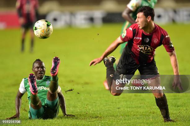 Kenya's club side Gor Mahia's Godfrey Walusimbi falls as he vies against Algeria's USM Alger's Qualid Ardji on May 16, 2018 at the Kasarani stadium...