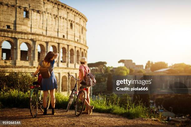 tourist women in rome: by the coliseum - city vacations stock pictures, royalty-free photos & images