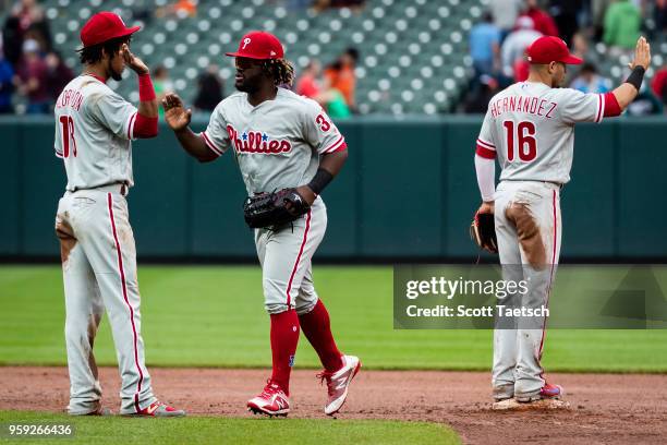 Pedro Florimon, Cesar Hernandez, and Odubel Herrera of the Philadelphia Phillies celebrate after the game against the Baltimore Orioles at Oriole...