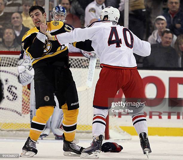 Milan Lucic of the Boston Bruins and Jared Boll of the Columbus Blue Jackets exchange punches in the first period on January 21, 2010 at the TD...