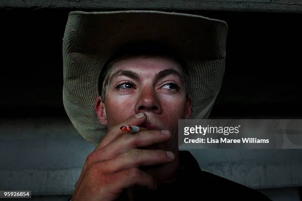 Bull rider Chris Lowe has a cigarette in the back stalls at the ABCRA National Rodeo Finals on January 21, 2010 in Tamworth, Australia. The National...