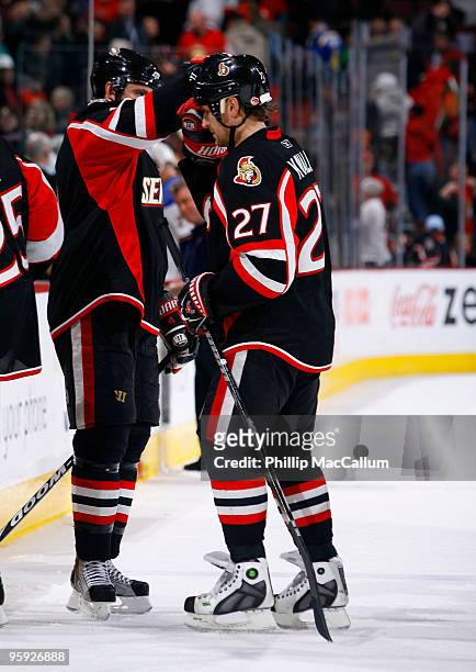 Alex Kovalev of the Ottawa Senators is congratulated by teammate Chris Phillips at the end of his 1200th regular season NHL game, a game against the...