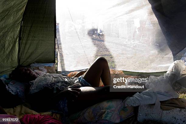 In this handout image provided by the United Nations Stabilization Mission in Haiti , an injured woman lies in a makeshift bed at a small Argentinian...