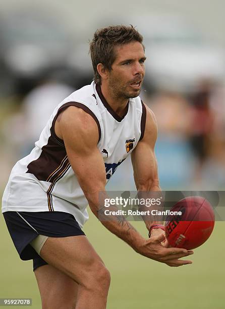 Chance Bateman of the Hawks handballs during a Hawthorn Hawks AFL training session at Toomuc Recreation Reserve on January 22, 2010 in Melbourne,...