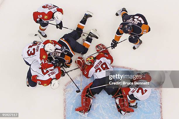 Tomas Vokoun of the Florida Panthers looks to cover the puck in his game against the New York Islanders at the Nassau Coliseum on January 21, 2010 in...