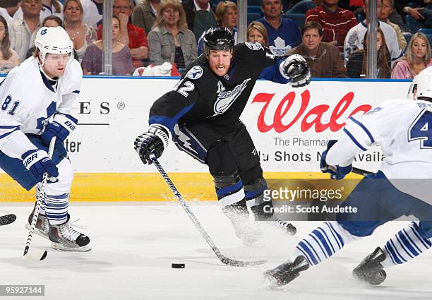 Ryan Malone of the Tampa Bay Lightning reaches for the puck against the Toronto Maple Leafs at the St. Pete Times Forum on January 21, 2010 in Tampa,...