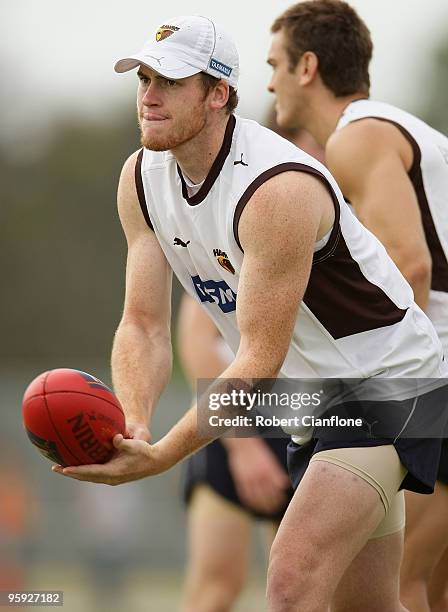Jarryd Roughead of the Hawks handballs during a Hawthorn Hawks AFL training session at Toomuc Recreation Reserve on January 22, 2010 in Melbourne,...