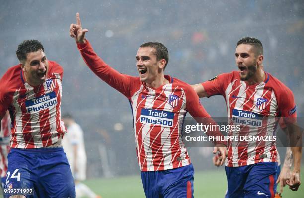 Atletico Madrid's French forward Antoine Griezmann celebrates with Atletico Madrid's Uruguayan defender Jose Gimenez and Atletico Madrid's Spanish...