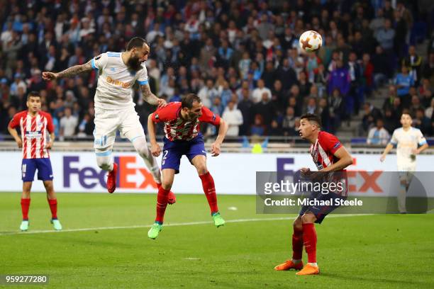 Kostas Mitroglou of Marseille heads goalwards under pressure from Diego Godin of Atletico Madrid during the UEFA Europa League Final between...