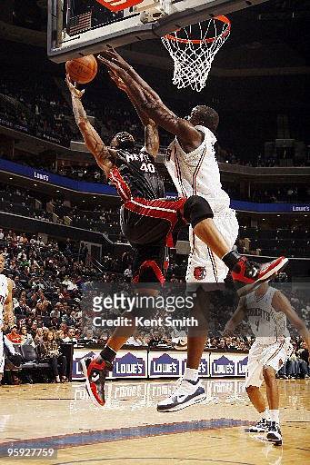 DeSagana Diop of the Charlotte Bobcats blocks against Udonis Haslem of the Miami Heat on January 20, 2010 at the Time Warner Cable Arena in...