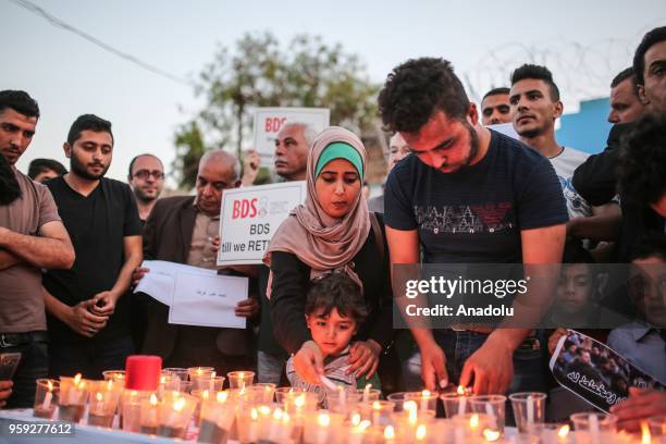 People light candles for the memories of Palestinians killed by Israeli occupation forces on protest held to mark 70th anniversary of Nakba, also...