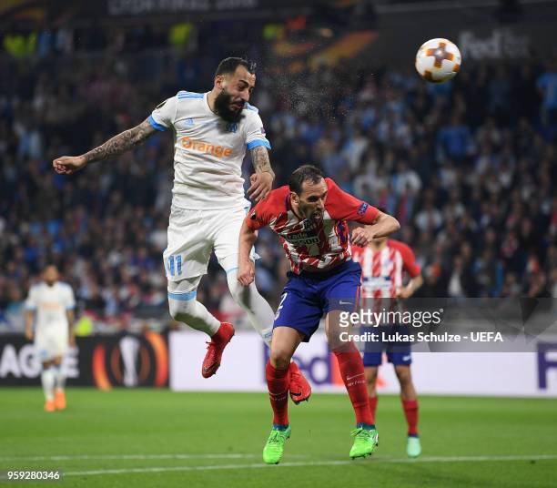 Kostas Mitroglou of Marseille wins a header from Diego Godin of Atletico Madrid but hits the post during the UEFA Europa League Final between...