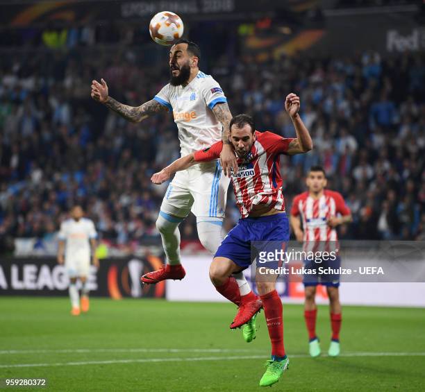 Kostas Mitroglou of Marseille wins a header from Diego Godin of Atletico Madrid but hits the post during the UEFA Europa League Final between...