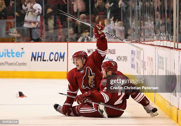 Scottie Upshall of the Phoenix Coyotes celebrates with teammate Jim Vandermeer after Upshall scored his third goal of the night against the Nashville...