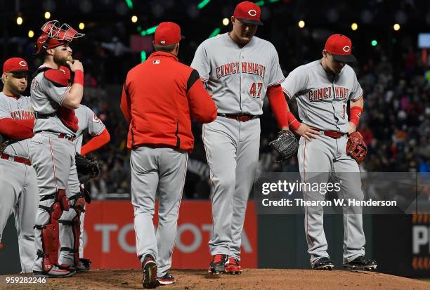 Interim manager Jim Riggleman of the Cincinnati Reds takes the ball from starting pitcher Sal Romano taking Romano out of the game against the San...