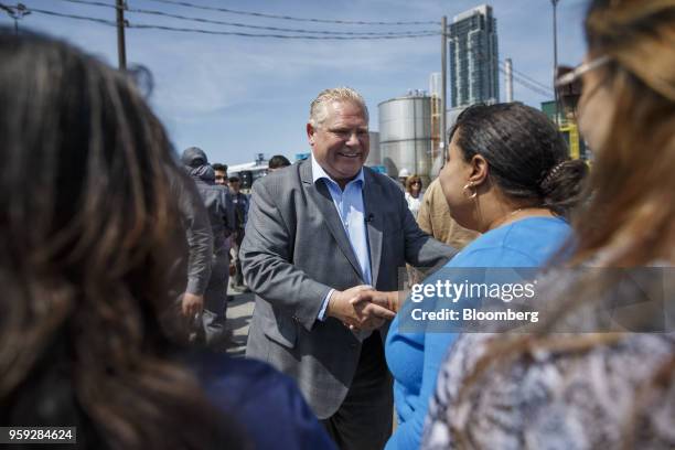 Doug Ford, Progressive Conservative Party candidate for Ontario Premier, center, greets employees during a tour of the Fielding Environmental...