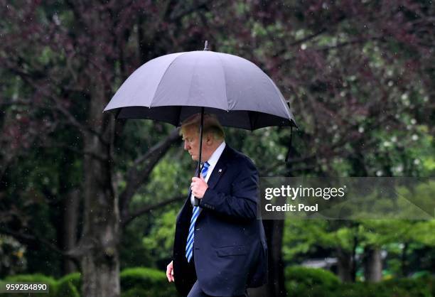 President Donald Trump walks towards Marine One while departing the White House to visit first lady Melania Trump at Walter Reed National Military...
