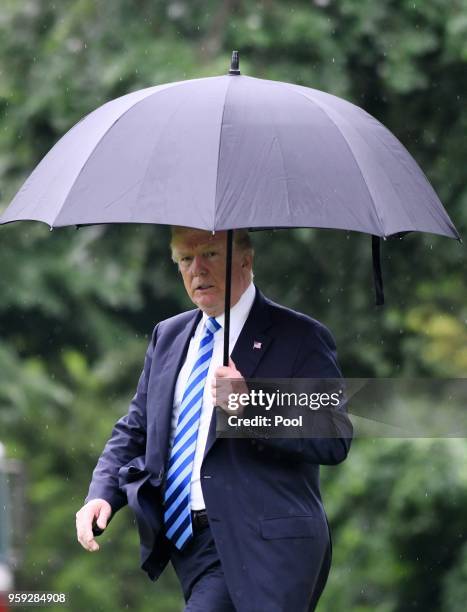 President Donald Trump walks towards Marine One while departing the White House to visit first lady Melania Trump at Walter Reed National Military...