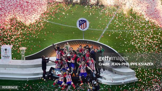 Atletico Madrid's players pose with the trophy after winning the UEFA Europa League final football match between Olympique de Marseille and Club...