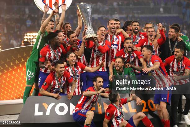 Gabi and Fernando Torres of Atletico Madrid lift the trophy with their team-mates at the end of the UEFA Europa League Final between Olympique de...