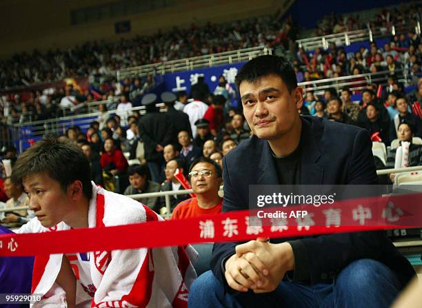 In a picture taken on January 20, 2010 NBA's Houston Rockets Yao Ming , the new owner of the China Basketball Association's Shanghai Sharks, watches...