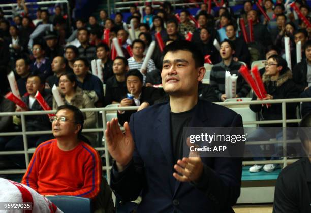 In a picture taken on January 20, 2010 NBA's Houston Rockets Yao Ming, the new owner of the China Basketball Association's Shanghai Sharks, applauds...