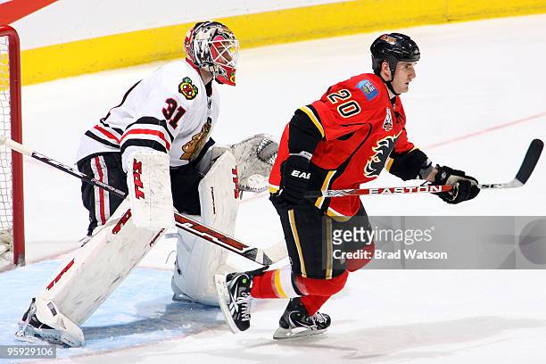 Curtis Glencross of the Calgary Flames skates in front of Antii Niemi of the Chicago Blackhawks on January 21, 2010 at Pengrowth Saddledome in...