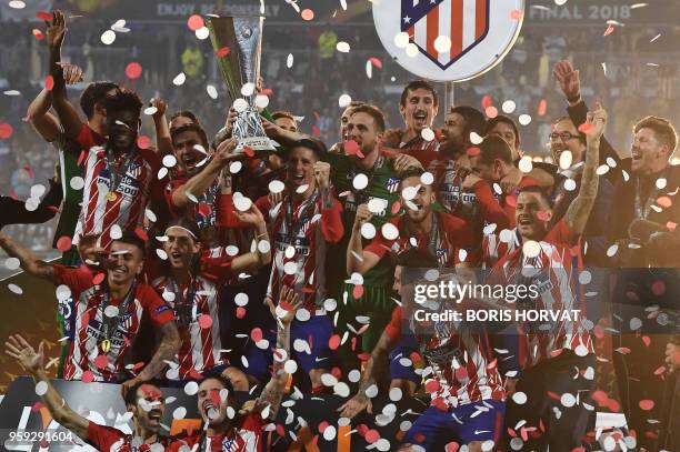 Atletico's players celebrate with the trophy after the UEFA Europa League final football match between Olympique de Marseille and Club Atletico de...