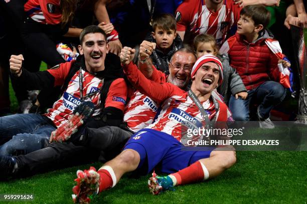 Atletico Madrid's French forward Antoine Griezmann celebrates their victory with his father Alain Griezmann after winning the UEFA Europa League...