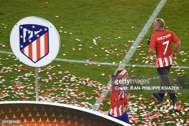 Atletico Madrid's French forward Antoine Griezmann celebrates their victory with his father Alain Griezmann after winning the UEFA Europa League...