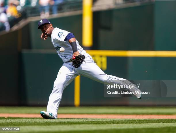 Jean Segura of the Seattle Mariners drops the ball to allow Isiah Kiner-Falefa of the Texas Rangers to reach first base in the fifth inning at Safeco...