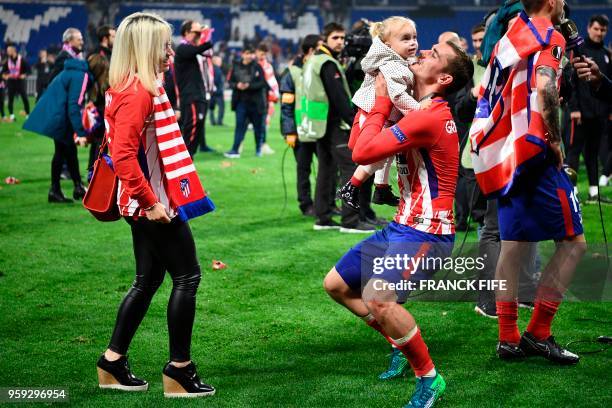 Atletico Madrid's French forward Antoine Griezmann celebrates with his daughter Mia Griezmann and his wife Erika Choperana after the UEFA Europa...