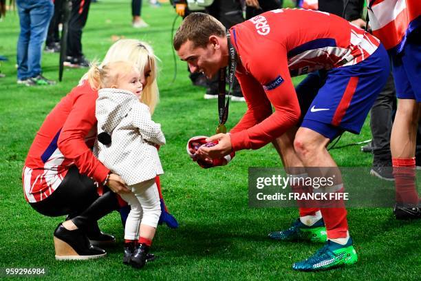 Atletico Madrid's French forward Antoine Griezmann celebrates with his wife Erika Choperana and his daughter Mia Griezmann after the UEFA Europa...