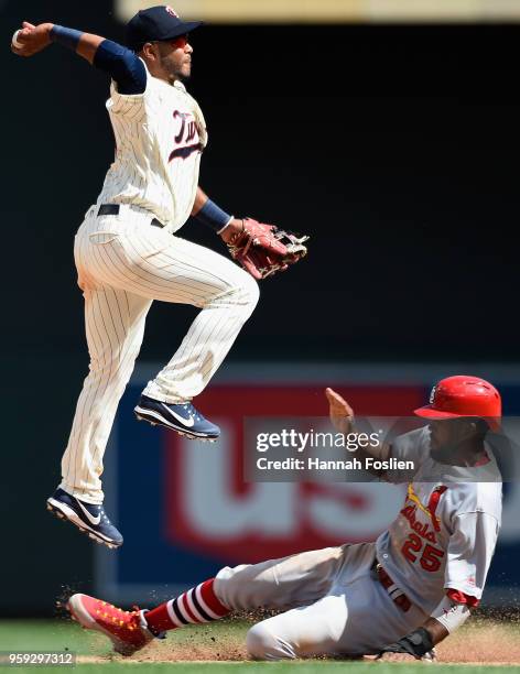 Dexter Fowler of the St. Louis Cardinals is out at second base as Gregorio Petit of the Minnesota Twins turns a double play during the ninth inning...